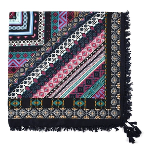 Close-up of bohemian square scarf featuring tribal jacquard patterns and navy blue tassels