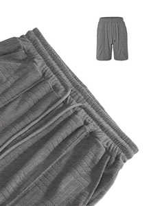 Close-up of dark grey men's shorts showing waffle knit texture and drawstring waist