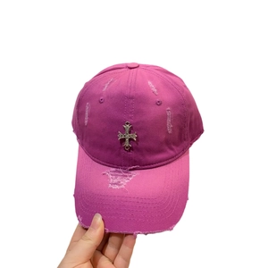 Distressed dark pink baseball cap with vintage metal cross and ripped cotton fabric
