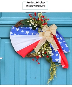 Detail of USA Independence Day wreath featuring burlap bow and red berries on blue door