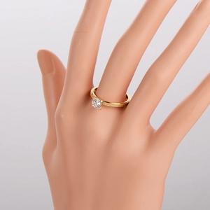 Frosted gold ring with single round zircon stone worn by a hand model for women