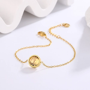 18K gold plated stainless steel bracelet featuring a round champagne crystal bezel setting