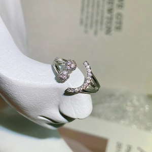 Macro detail of silver adjustable smile ring with sparkling rhinestones on model nose