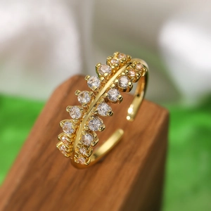 Macro shot of gold plated open ring with double row zircon and geometric metal ridge