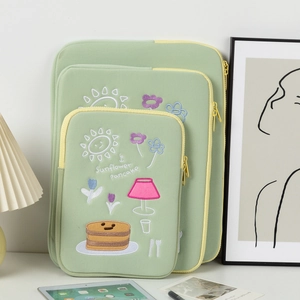 Three-piece set of green laptop sleeves with yellow trim and sunflower pancake embroidery