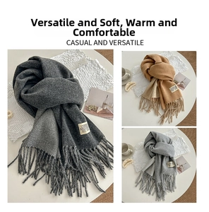 Close-up of fringe detail and woven labels on warm solid color pashmina scarves