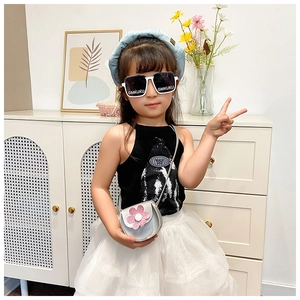 Detail of white square sunglasses and silver sequin flower crossbody bag for girls