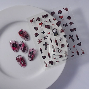 Detailed view of Gothic rose and cross nail stickers on white ceramic plate background