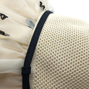 Detail of lace butterfly mesh and woven texture on a summer sun protection beach hat