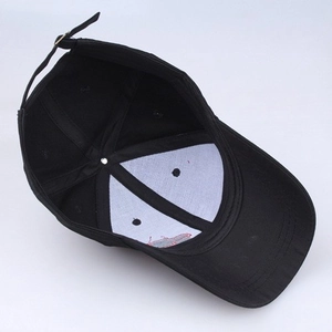 Internal view of black cotton baseball cap showing stitching and adjustable metal buckle
