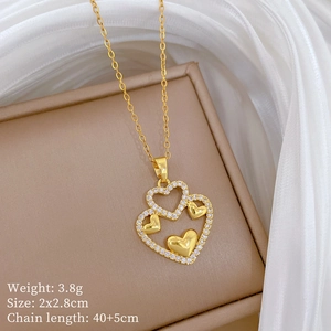 Elegant gold heart pendant necklace with cubic zirconia inlay on a silk background
