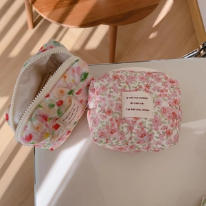 Quilted floral cotton makeup pouch with pink flower print and secure top zipper closure