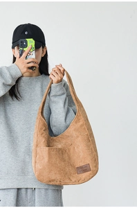 Detailed close-up of corduroy shoulder bag showing fabric texture and 7Street leather tag