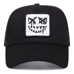 Black trucker hat with mesh back and embroidered devil face patch on front panel