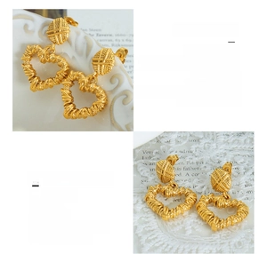 Detail of 18K gold plated heart earrings featuring a unique spiral texture and 3D design
