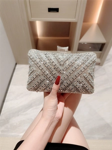 Elegant silver evening clutch bag featuring rhinestone diamond patterns and chain strap