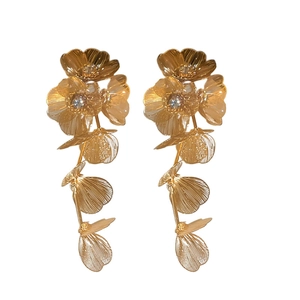 Elegant gold flower tassel earrings with long fringe design in professional white studio background