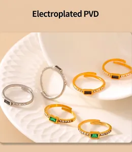Detailed view of PVD plated square gemstone rings in gold and silver on a white tray