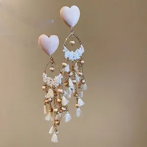 French vintage heart earrings with white beaded tassels and elegant gold accents