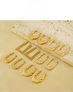 Detail of five 18K gold plated stainless steel geometric earrings with unique textures