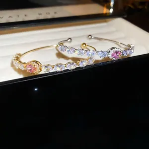 Luxury open bangle with pink oval gemstone and zircon accents in gold and silver finish