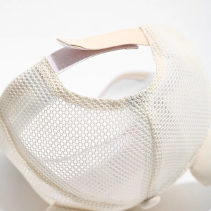 Detail of breathable mesh back and adjustable velcro strap on kids beige baseball cap