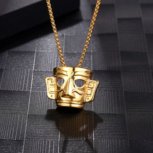 Vintage gold Sanxingdui mask pendant necklace in titanium steel on a black textured background