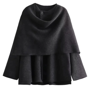 Detail of black wool knit poncho top featuring a single button and layered design