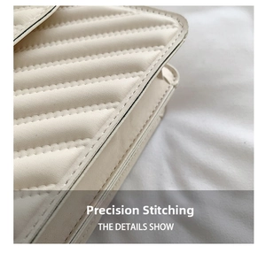 Detail showing the neat diagonal quilting and precise stitching on the beige leather bag