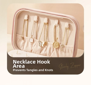 Pink velvet jewelry box detail showing five necklace hooks and elastic storage pockets
