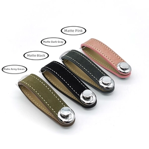 Detailed view of leather key organizers in pink, dark grey, black, and army green