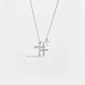 Minimalist S925 sterling silver necklace with textured cross pendants on white background