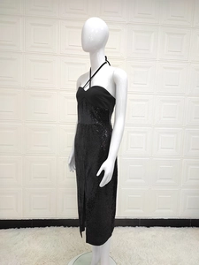Close-up of a black sequin halter dress featuring a stylish side slit and shimmer fabric
