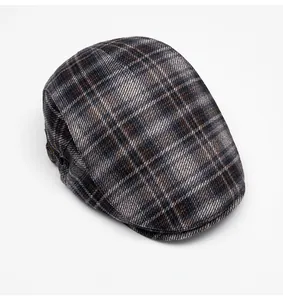 Top view of classic newsboy cap featuring a vintage brown and grey plaid tweed pattern