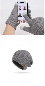 Detail of dark grey knit winter hat with fleece lining and touch screen gloves set