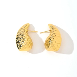 Detail of 14K gold leaf earrings featuring a unique 3D quilted grid textured finish