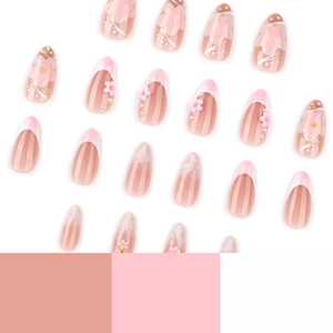 Pink almond press-on nails with 3D resin flowers, pearls, and gradient French tips