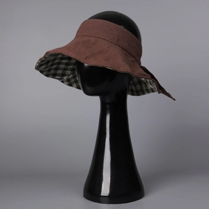 Detail of linen sun visor with brown exterior and black-white checkered lining