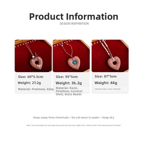 Detailed display of lava stone heart necklaces with pearls on a red velvet jewelry tray