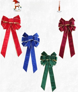 Macro shot of velvet Christmas bows with gold stitched edges in four festive colors