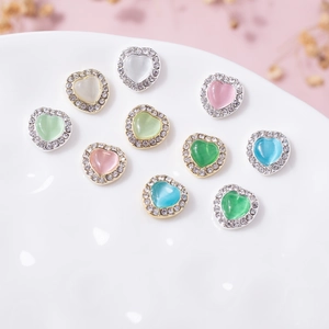 Cat eye heart nail charms with rhinestones in various colors for manicure