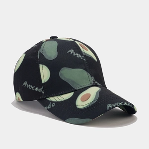 Close-up of green avocado pattern and typography on a black cotton baseball cap