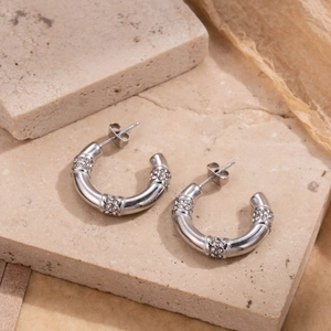 Bamboo-style silver stainless steel hoop earrings with sparkling zircon gemstones