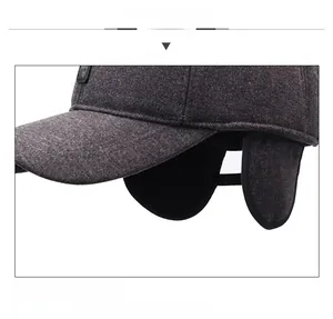 Detail of dark grey winter baseball cap with thick wool texture and fold-down ear flaps