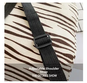 Detail view of adjustable black nylon straps on a white plush tiger striped kid backpack