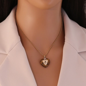 Golden titanium necklace with heart shaped brown tiger eye stone pendant and blue gem