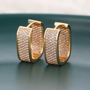Macro shot of gold-plated rectangular earrings with micro-pave cubic zirconia crystals