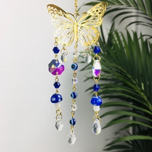 Detail of evil eye car hanging ornament with gold butterfly and crystal beads charms