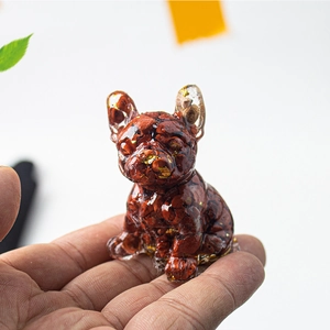 Handheld resin French bulldog figurine with natural red stone and gold leaf details