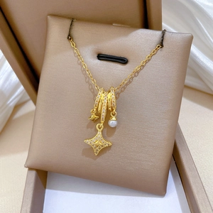 Luxurious gold star and pearl necklace with sparkling crystals in an elegant jewelry box